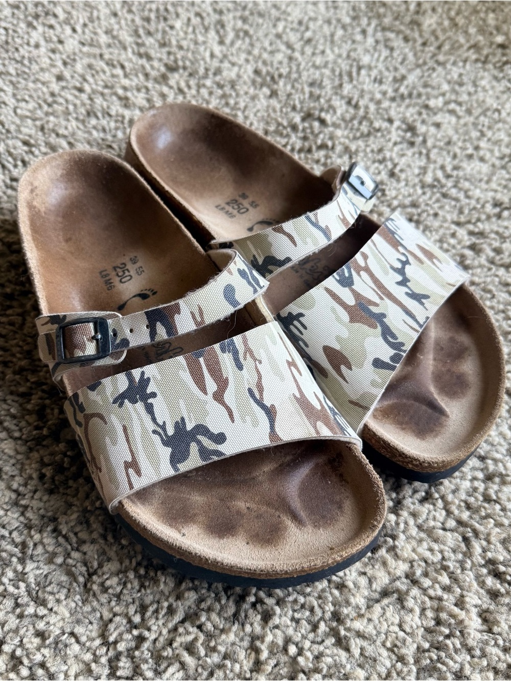 Birkenstock Arizona two-strap sandals featuring a camouflage pattern L8 M6